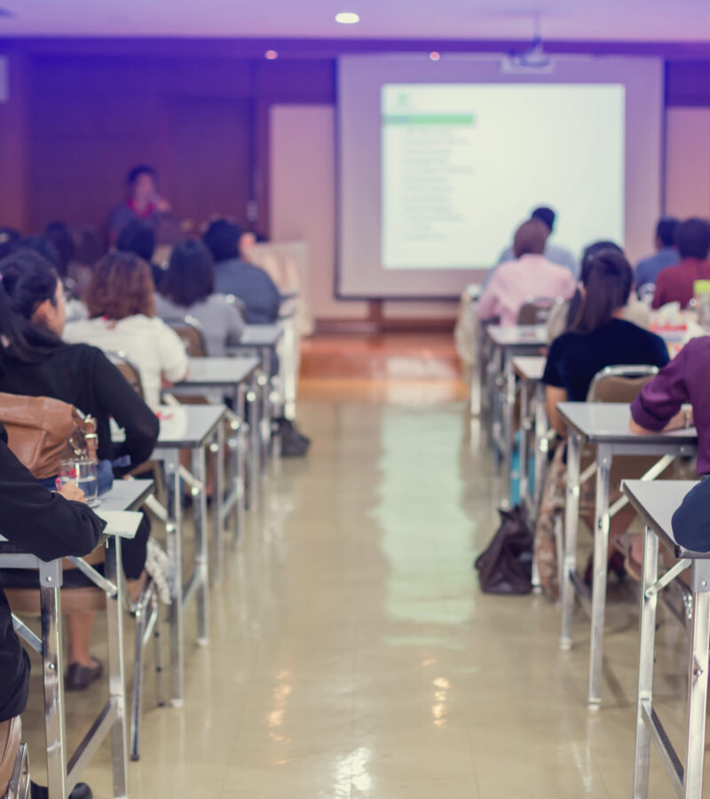 selective focus to business woman and man with blurry speaker for meeting or seminar event in the meeting room. They are brain business solving problem and brain training concept.